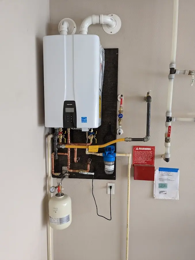Professional plumber installing copper piping in a Forest Glen home